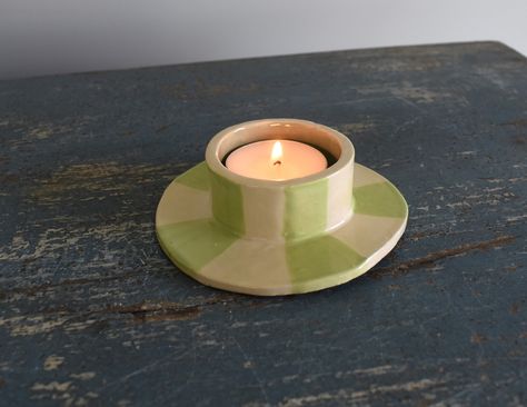 A hand sculpted ceramic tea light candle holder with a aqua blue interior and a candy green striped exterior. Handbuilding Pottery Ideas Candle Holders, Pottery Votive Candle Holders, Handbuilt Candle Holders, Diy Tea Candle Holders, Homemade Clay Candle Holders, Home Made Candle Holders, Ceramic Tea Candle Holders, Tea Light Ceramic, Candle Holder Ceramics