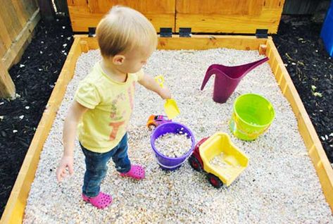 Switching from sand to a rock box with pea gravel... Might be easier to contain and deal with in the wet winter though harder to mold. Sandbox Alternative, Build A Sandbox, Sandbox Cover, Rock Box, Indoor Playhouse, Build A Playhouse, Young House, Sand Play, Pea Gravel