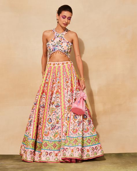 Featuring a blush pink lehenga in raw silk and tulle base with floral print. It is paired with a matching embroidered blouse and a potli bag. Blush Pink Lehenga, Modern Lehenga, Floral Print Lehenga, Lehenga And Blouse, Print Lehenga, Mirror Embroidery, Potli Bag, Pink Lehenga, Lehenga Blouse