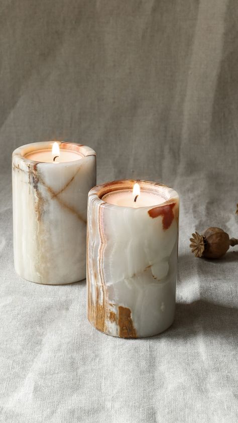 Bring a wonderful warm glow to your home or garden with our beautifully simple yet striking pillar tealight holders. Made using marble from the foothills of the Himalayan mountains. Spread them along your mantelpiece or create a cosy outdoor scene, these tealight holders are effortlessly stylish. Available in black marble or onyx. Marble is a completely natural stone and so each tealight holder will differ in colour and pattern making them truly special. Marble Accessories Decor, Onyx Bathroom Accessories, Scandinavian Japandi, Candles Outdoor, Montana Decor, Onyx Candle Holder, Onyx Lamp, Marble Candle Jar, Stone Candle Holder