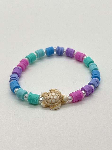 Handmade 7 in. preppy beaded bracelet. Contains pink, purple, blue, and teal 6mm clay beads. Also has pearl beads, and a cute turtle bead!! This is a super cute summer bracelet that reminds me of a mermaid bracelet! It's perfect for a gift for yourself or anyone else!!  I can custom create any jewelry for you. Just let me know what colors you want, and if you want a word on it or not. I can also make phone charms and rings, and necklaces. Pink Clay Bead Phone Charm, Clay Bead Summer Bracelets, Pastel Clay Bead Bracelet Ideas, Cute Ideas For Bracelets, Beading Bracelets Ideas, Turtle Clay Bead Bracelet, Polymer Clay Bracelet Ideas Aesthetic, Cute Clay Bracelets, Clay Bead Brackets