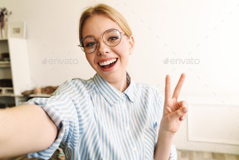 Photo of joyful blonde woman showing peace sign while taking selfie by vadymvdrobot. Photo of joyful blonde woman in eyeglasses showing peace sign while taking selfie photo at office #Sponsored #woman, #showing, #peace, #Photo Peace Sign Drawing, Woman Architect, Waving Hand, The Office Characters, Photo Of Woman, How To Shade, Blonde Woman, Sms Marketing, Figure Poses