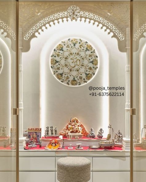 Introducing the exquisite White Marble Mandir by Harishyam Arts, a perfect blend of traditional craftsmanship and modern elegance. This masterpiece features intricate marble jali arch designs, hand-carved with precision to bring a touch of divinity into your home. The stunning centerpiece is a circular inlay adorned with floral motifs and the sacred "Om" symbol, meticulously crafted using fine inlay work that adds a luxurious feel to the temple. Each detail, from the ornate pillars to the de... Marble Mandir For Home, Marble Tulsi Mandir, Marble Puja Mandir, Seven Wood Mandir, Makrana Marble Mandir, Om Symbol, God Illustrations, White Marble, Plant Decor