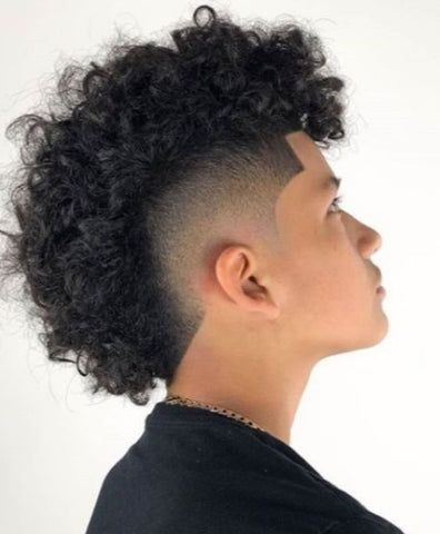 The Afro Hawk with a mid taper for black men is a dynamic hairstyle that combines the natural texture of an afro with the boldness of a mohawk. The Afro Hawk with a mid taper is not just a hairstyle; it's a statement, allowing black men to embrace their individuality with confidence and style. Afro Hawk, Frohawk Fade, Mid Taper, Skin Fade Hairstyle, Man Haircuts, Curly Mohawk Hairstyles, Short Sides Long Top, Male Haircuts Curly, Top Hairstyles For Men