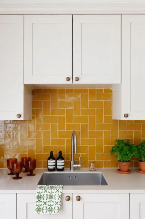 a white shaker style kitchen with a bold yellow tile backsplash that makes a color statement and creates a mood in the space Yellow Tile Backsplash, Yellow Tile Kitchen, Yellow Kitchen Tiles, Unique Tile Backsplash, White Shaker Style Kitchen, Colorful Kitchen Backsplash, Shaker Style Kitchen, White Kitchen Tiles, White Shaker Kitchen