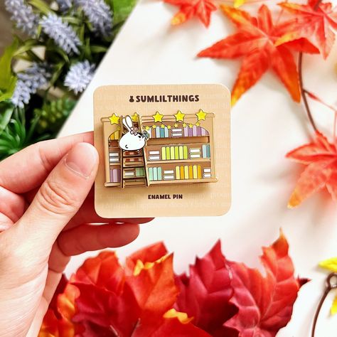 Mimi's Bookshelf Enamel Pin - Interactive slider lets you choose your favorite book! #enamelpin #booklover #bookish #reading . #Sticky_Note_Planner #Notes_Stationery #Enamel_Pin_Collection #Journaling_Kits Enamel Pin Display, Sticky Note Planner, Notes Stationery, Enamel Pin Collection, Color Palette Yellow, Journaling Kits, Planning Stickers, Be Present, Cute Pins