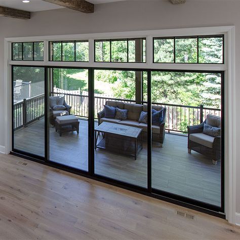 Glass Doors Out To Patio, Large Black Sliding Glass Doors Patio, Back Patio Windows, Great Room Patio Doors, Cascading Sliding Doors, Patio Doors With Transom Windows, Retractable Glass Doors Patio, Sliding Window Doors Living Rooms, Modern Farmhouse Patio Doors