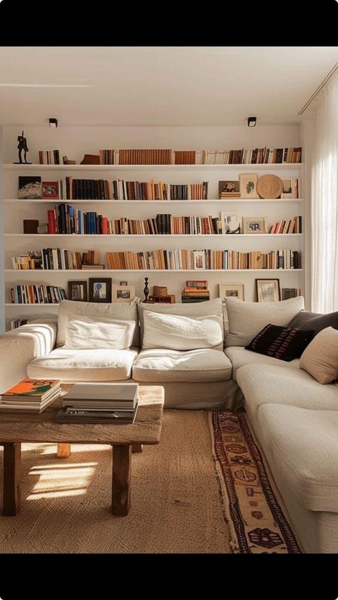 Full Wall Of Shelves, Floating Shelves Living Room Books, White Library Wall, Library Wall Shelves, Living Room Designs Library, Shelving Unit Behind Couch, Floating Bookshelf Living Room, Wall Library Ideas, Living Room With Library Wall