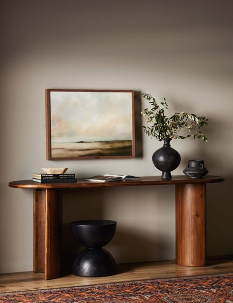 Clad in acacia, the soft lines of the Gilda console table are reflected in the curved legs, offering a sturdy design with a gently rounded profile that feels sculptural yet grounded. This wood console table is set to elevate your entryway or living room with the perfect touch of surface space.