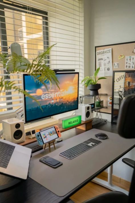 This sleek and modern desk setup creates the perfect balance between productivity and relaxation. With clean lines, a multi-screen workstation, and a relaxing ambiance enhanced by plants and soft lighting, it’s ideal for both work and leisure. The desk is equipped with all essentials, from a Nintendo Switch for breaks to a wireless keyboard and laptop stand for seamless work. Perfect for anyone looking for home office inspiration that is both functional and stylish. Macbook Desk Setup Aesthetic, Laptop And Monitor Desk Setup, Modern Desk Setup, Ideal Workplace, Home Studio Desk, Workstations Design, Boys Room Design, Home Office Inspiration, Multi Screen