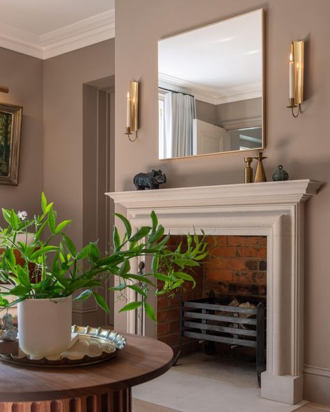 A fireplace can change a room and make a home, especially when it’s from @jamb_london. After the original fire surround was accidentally removed, we used the opportunity to specify a bespoke chimney piece in Portland Stone, referencing the external window reveals of the Victorian part of the house. We paired it with a pair of brass Scandinavian candle sconces and a beautifully simple mirror, keeping the chimney piece as the star of the show. Photography by @matthiaspeters.photography #s... Stone Living Room, Farrow And Ball Living Room, London Stone, Simple Mirror, Show Photography, Wall Table Decor, Portland Stone, Outdoor Living Furniture, Fire Surround