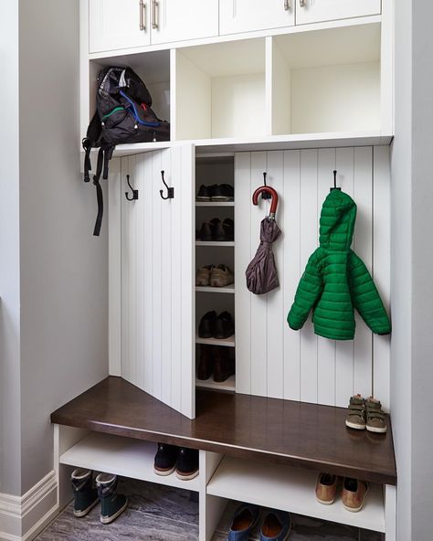 Our creative mudroom design features hidden shoe storage cabinets behind panelled doors dressed with coat hooks, perfect for a family. #allanchandondesign #mudroomdesign #familyfriendlydesign #customcabinetry #shoestorage #transitionaldesign #torontointeriordesign #torontodesigner #etobicoke #torontocustomhomes 📷@valeriewilcox Skjulte Rum, Ikea Shoe Storage, Vstupná Hala, Farmhouse Mudroom, Ikea Shoe, Coat Closet Organization, Paint Cabinets White, Entryway Closet, Cabinets Painted