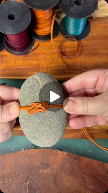 Lori Marshall on Instagram: "When you love what you do!" Weaving Around Rocks, Diy Rock Wrapping, Rock Wrapping Diy Tutorial, What To Do With Rocks, Weaving On Rocks, Rock Sculpture Diy, Ribbon Weaving, Rock Wrapping Diy, Wrapped Stones