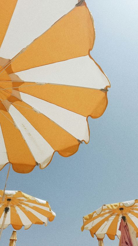 A bright and cheerful summer scene in Sanremo, Italy, featuring a row of yellow and white striped umbrellas set against a brilliant blue sky. The umbrellas, positioned along the sandy beach, create a vibrant and inviting atmosphere, perfect for a day of relaxation by the Mediterranean Sea. The contrasting colors of the yellow and white umbrellas against the deep blue sky emphasize the sunny, warm weather typical of summer in Sanremo. This image encapsulates the joyful and leisurely spirit of a summer day in this beautiful Italian coastal town, where the seaside and the sun play a central role in the local lifestyle. Italian Beach Aesthetic, Vintage Beach Aesthetic, Aesthetic Umbrella, Italian Festival, Bondi Boost, Sanremo Italy, Italian Vibes, Italian Beach, Mediterranean Vibes