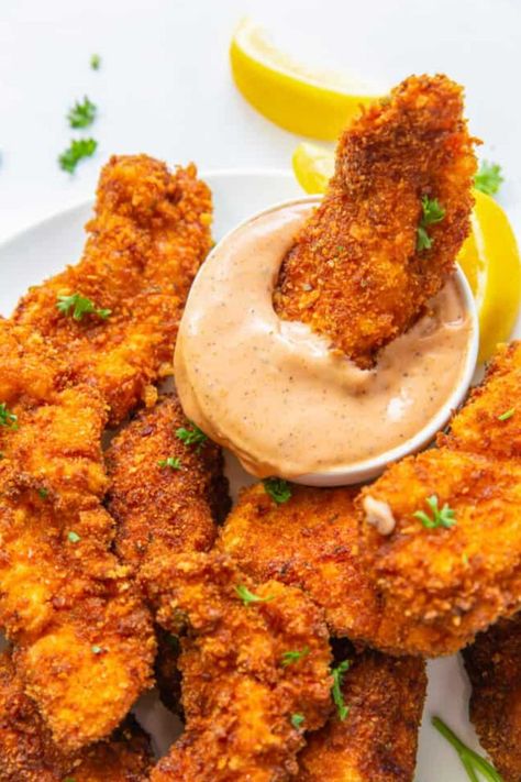 These Copycat Raising Cane’s Chicken Fingers come with an addictive Creole sauce. No deep fryer? No problem! Fried in vegetable oil, these juicy strips come out golden brown and delicious, they are utterly addictive! Tender chicken strips coated in a delicious and crispy breading. Plus they are so easy to make. Canes Fried Chicken Recipe, Easy Goulash, Canes Chicken, Chicken Finger Recipes, Cilantro Recipes, Flank Steak Recipes, Raising Canes, The Cookie Rookie, Cookie Rookie