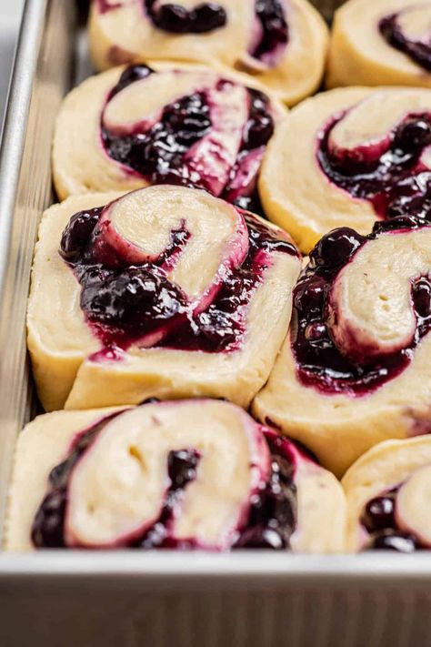 side view of blueberry rolls. Triple Berry Cinnamon Rolls, Homemade Blueberry Cinnamon Rolls, Blueberry Sourdough Cinnamon Rolls, Blueberry Cream Cheese Sweet Rolls, Blueberry Cream Cheese Cinnamon Rolls, Blueberry Cinnamon Roll Bake, Blackberry Sweet Rolls, Spring Cinnamon Rolls, Blueberry Lemon Cinnamon Rolls