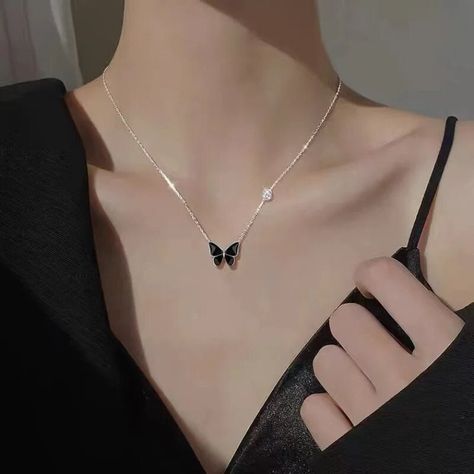 This pendant features a stunning black butterfly delicately suspended from a dainty chain, creating a mesmerizing focal point that draws the eye.  The sleek black hue adds a timeless appeal, perfect for complementing any outfit, whether it's a casual ensemble or a sophisticated evening attire. Wear it as a statement piece to add a touch of intrigue to your look, or layer it with other necklaces for a stylish, layered effect. This pendant necklace is not just a beautiful accessory; it's also a sy Collar Chain, Butterfly Pendant Necklace, Chain Fashion, Neck Chain, Choker Style, Black Butterfly, Trendy Necklaces, Collars For Women, Fancy Jewelry