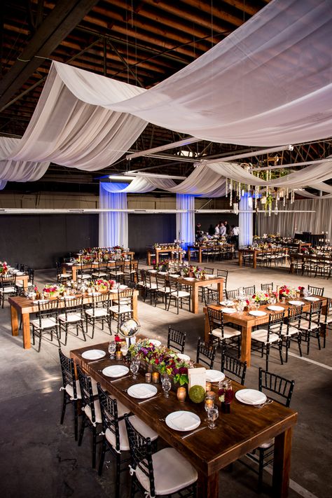 Long rectangular tables in a warehouse wedding reception venue {Photo by Viera Photographics via Project Wedding} Warehouse Wedding Reception, Rustic Barn Wedding Decorations, Seating Wedding, Reception Layout, Wedding Reception Lighting, Wedding Ceiling, Ceiling Draping, Wedding Reception Seating, Barn Wedding Decorations