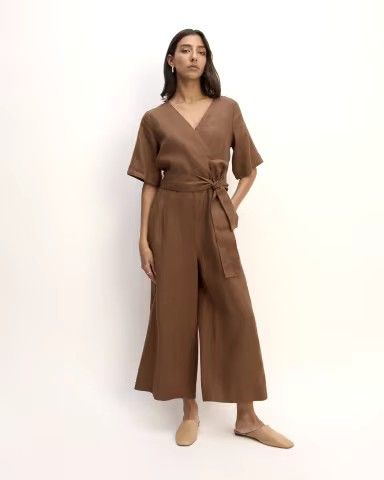 Embrace effortless elegance with The Wrap Jumpsuit in Linen in Brown. This stylish jumpsuit features a flattering wrap design and breathable linen fabric, perfect for both casual and dressy occasions. The rich brown hue adds a touch of sophistication, while the versatile silhouette ensures comfort and chic style. Shop now to elevate your wardrobe with this must-have, modern jumpsuit! Brown jumpsuit. Culotte Style, Vintage Suede Jacket, Wrap Jumpsuit, Guest Attire, Wedding Attire Guest, Linen Jumpsuit, Professional Outfits, Elbow Length Sleeve, Linen Women