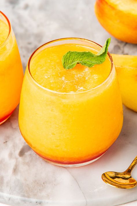 This refreshing Frozen Peach Bellini combines peaches and sparkling wine for the perfect summer cocktail. An easy frozen drink made with simple ingredients! Bellini Recipe Easy, Frozen Peach Cocktail, Frozen Peach Bellini Recipe, Peach Cocktail Recipe, Bellini Cocktail Recipes, Mimosa Recipes, Peach Bellini Recipe, Peach Bellini Cocktail, Frozen Peach Bellini