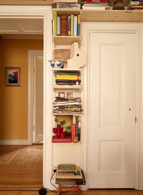 A Cozy Swedish Apartment Filled with Charm 9 Books Around Doorway, Book Shelf Small Apartment, Book Shelf Above Window, Diy Wooden Shelves Living Room, Shelves Over Doorway, Office Book Nook, Swedish Apartment Decor, Small House Book Storage, Bookshelf Above Door