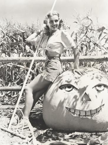 size: 24x18in Photo: Woman Leaning on Large Jack O'Lantern on Farm : Artists Halloween Pinup, Jack O Latern, Halloween Pin Up, 50s Art, Photo Woman, Vintage Clown, Vintage Interior Design, Holiday Images, Farm Photo