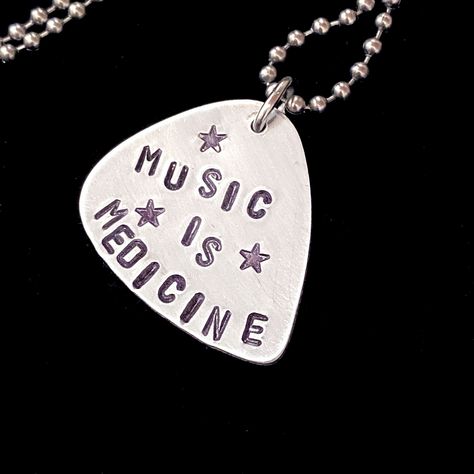 "Guitar Pick hand stamped \"Music is Medicine\". Aluminum guitar pick on Stainless Steel ball chain with retro connector \"clasp\" ~OR~ on Stainless steel keychain. Since each letter/symbol is stamped individually,  placement may vary slightly from photo. Great gift for musicians...or yourself! Please choose chain length.  Custom orders available! This listing is for ONE necklace (or keychain).... last photo shows a few other examples.  RocK On" Guitar Pick Necklace Diy, Music Is Medicine, Cool Guitar Picks, Keychain Music, Music Gift Ideas, Guitar Pick Keychain, Guitar Jewelry, Guitar Pick Jewelry, Pick Necklace