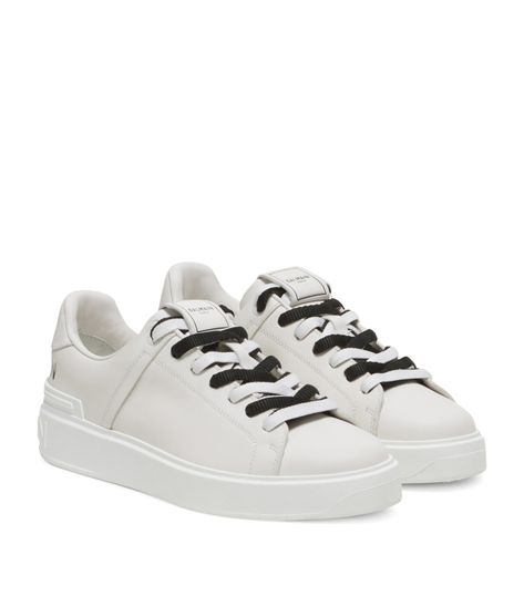 Find BALMAIN Leather B-court Sneakers on Editorialist. For those in search of a more refined Balmain shoe, the B-Court sneakers strike a perfect balance between sophistication and contemporary relevance. Adorned with the Houses iconic logo, these shoes will lend themselves to elevate your capsule wardrobe, courtesy of Olivier Rousteings trail-blazing vision. Balmain Shoes, White Sneakers Men, Olivier Rousteing, Iconic Logo, Casual Shoe, Latest Sneakers, Perforated Leather, Fashion Logo, White Shoes