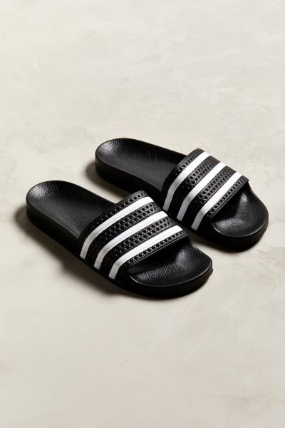 Favorite pool slides from adidas. Slip-on silhouette offers a textured three-stripe foot strap and a contoured footbed for comfort. Finished with a grippy rubber outsole.Content + Care. Rubber Spot clean Imported Adidas Slides Outfit, Sport Sandals Outfit, Adidas Sandals, Slides Outfit, Wu Wear, Image Moto, Mens Slide Sandals, Adidas Slides, Men Slides