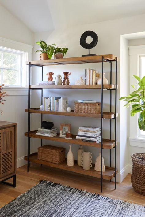 Crafted of wood with a warm vintage-acorn finish, the Kaili Bookshelf features rectangular open shelves in a sleek matte-black metal frame. Designed for versatile uses, this bookshelf is perfect for arranging with decor or plants in the living room, using as open storage in the bedroom or office and organizing serveware in the dining room or kitchen. #WorldMarket #AntonOfficeCollection #HomeOffice #HomeDecor Black Metal Bookshelf, Market Shelf, Wood Shelves Living Room, Office Furniture Decor, Unique Living Room Furniture, Wardrobe Laminate Design, Dining Room Shelves, Small Apartment Bedrooms, Shelf Decor Living Room