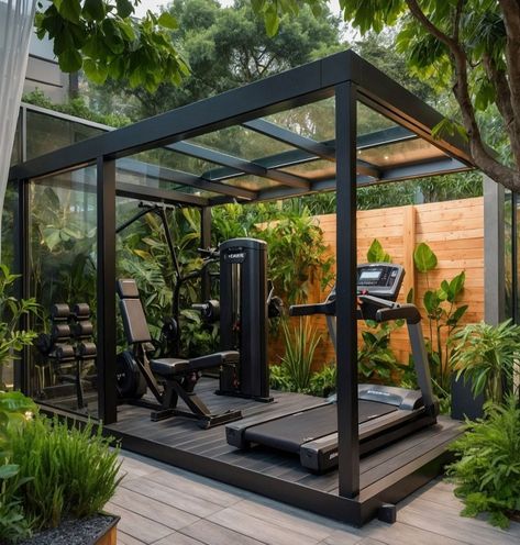 Experience the perfect blend of nature and fitness with this modern outdoor gym! Set in a lush garden, this sleek gym features a glass roof and black metal frame, equipped with top-of-the-line fitness gear including a treadmill, weight bench, and a multifunctional training machine. Surrounded by vibrant greenery, this serene and invigorating space is ideal for those who love to...#Training #Building #and #Muscle #Fitness #NutritionTips #Enhancing #Strength #HealthyLiving #HealthTips #SelfCare Outdoor Gyms Ideas, Gym In Garden, Outside Gym Ideas, Garden Shed Gym, Outside Home Gym, Gym At Home Design, Outside Gym Ideas Backyards, Home Gym Shed Ideas, Garden Gym Outdoor