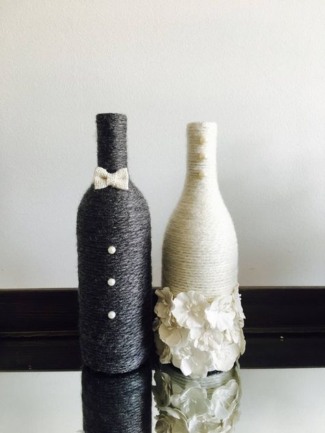 Congratulations to the newly engaged couple! These wine bottles are wrapped in charisma yarn and polished off with embellishments to represent the bride and groom. Display them at your engagement party, bridal shower and wedding! The price reflects ONE wine bottle so you can choose what fits Wine Bottle Wedding Centerpieces, Cheap Wedding Table Centerpieces, Bridal Shower Pictures, Bottle Decorations, Wine Bottle Centerpieces, Wedding Wine Bottles, Bridal Shower Decorations Diy, Bottle Centerpieces, Wedding Gifts For Bride And Groom