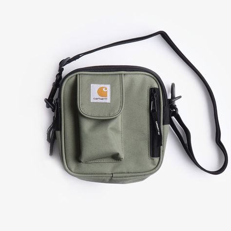 The Carhartt WIP Essentials Bag in Dollar Green is a practical and stylish everyday bag. Crafted from 97% recycled polyester and 3% polyurethane, this bag is fully lines for extra protection and is water-repellent. Featuring two main openings that are fastened with a two-way zipped closure for secure storage. The bag is also equipped with an adjustable shoulder strap, a velcro pouch detailed with a Square label and a small zipped front pocket for additional storage. One size: 17 x 16.5 x 6 cm / Carhartt Wip Essentials Bag Black, Carhartt Essentials Bag, Carhartt Wip Essentials Bag, Green Dollar, Essential Bag, Carhartt Wip, Everyday Bag, Free Shopping, Repellent