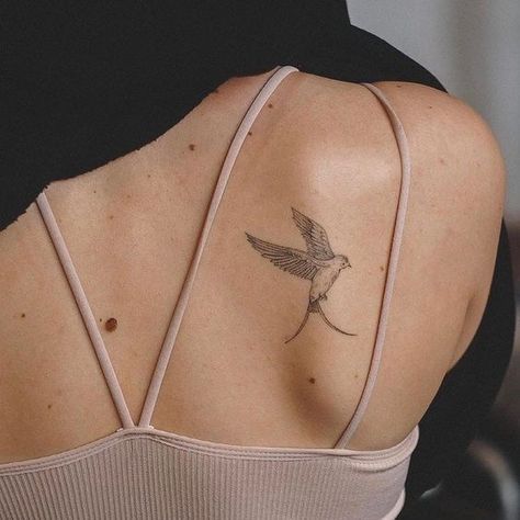 Learn the swallow tattoo meaning, its belonging to different cultures, and to whom such a design will suit the most. Bonus: the best unique designs inside. Swallow Tattoo Meaning, Aesthetic Tattoo Ideas, Bird Tattoos For Women, Vogel Tattoo, Unique Tattoo Ideas, Simple Tattoos For Women, Shoulder Blade Tattoo, 20 Aesthetic, Swallow Tattoo