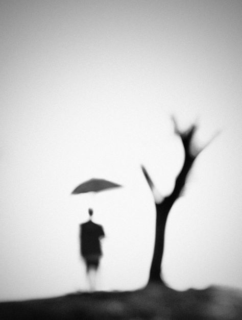 This photo is interesting because there is no background, just the tree, the person and the umbrella which looks like it is floating because the stick is out of focus and cannot be seen. Blur Photography, Figurative Abstract, 흑백 그림, Photo D Art, Focus Photography, Pretty Pics, Out Of Focus, Visual Poetry, 판타지 아트