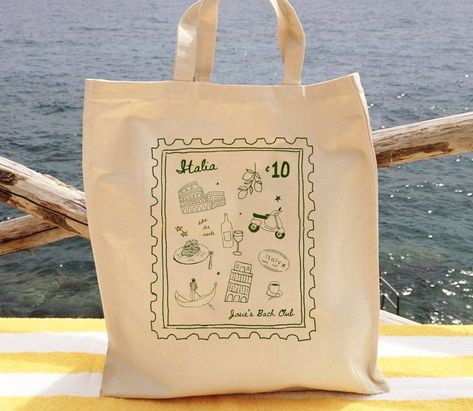 The cutest add on to your bachelorette, wedding, or girls trip! Fill these custom Italy stamp totes with all things needed for your vacay! Add personalized text and change the color! 🇮🇹 Current processing times: 1-2 business days PLEASE PLEASE READ ALL OF THIS BEFORE YOU PURCHASE!😊 - PLEASE NOTE COLOR CHART IS FOR THE DESIGN NOT THE BAG :) Bags are all the same white/cream color - Personalization is for any extra text you are wanting to add to the design to make it special to you! - Font is f Italy Themed Bridesmaid Proposal, Italy Welcome Party, Wedding Tote Bags Gift Ideas, Chic Party Bags, Italy Bridesmaid Proposal, Custom Wedding Favors, Bachelorette Bag Ideas, Wedding Bags For Guests, Custom Tote Bag Aesthetic