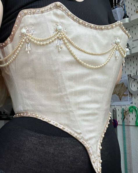 Simone Maria on Instagram: "I decorated my 1896 silk corset bodice with pearls and beads along the edges ✨ I might add more pearls later, but it will depend on the style of the skirt 😊 This project is made in collaboration with @muse.opheliaelysian who inspired me to start this project, and has helped me throughout the creative process ✨ #historicalcorsets #corset #corsetry #silk #historical #historicalcostume #historicalcostuming #19thcentury #18thcentury #pearls #1890sfashion #1890s #sewing # Corset With Beads, Haute Couture Corset, Pearls Corset, Baroque Corset, Pearl Bodice, Pearl Corset, Make A Corset, Corset Aesthetic, Beaded Corset