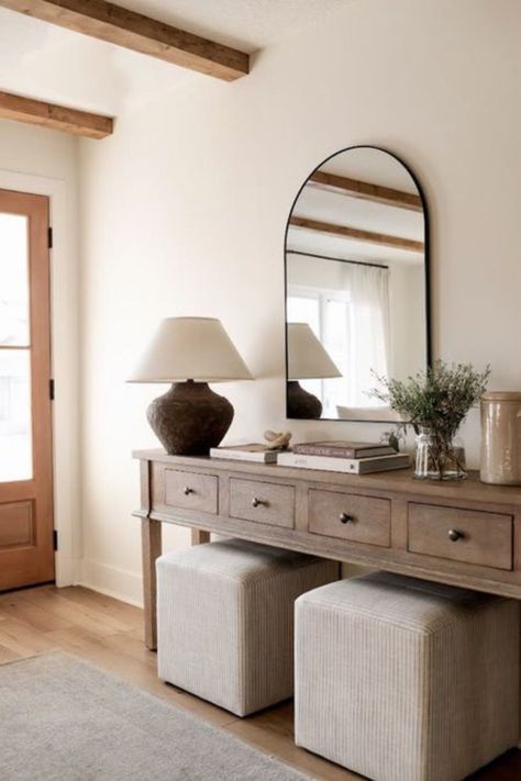 Looking for tips on how to style your entryway table including a modern organic console table? Halfway Wholeistic shares this neutral entryway decor including an arch mirror, vintage lamp, neutral coffee table books and faux greenery. Follow for more home styling tips and affordable home decor. Neutral Entryway, Style A Console Table, How To Style A Console Table, Halfway Wholeistic, Foyer Decor, Entryway Furniture, How To Style, Console Table, Dresser