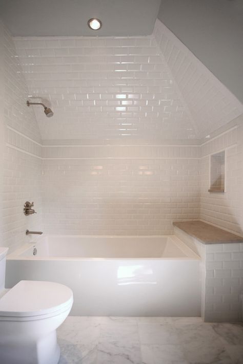 Amazing attic bathroom features glossy white bathtub tucked under dormer accented with white ... White Beveled Subway Tile, White Bathtub, Built In Bathtub, Bathtub Tile, Bathroom Features, Attic Bathroom, Tub Tile, Tub Surround, Transitional Bathroom