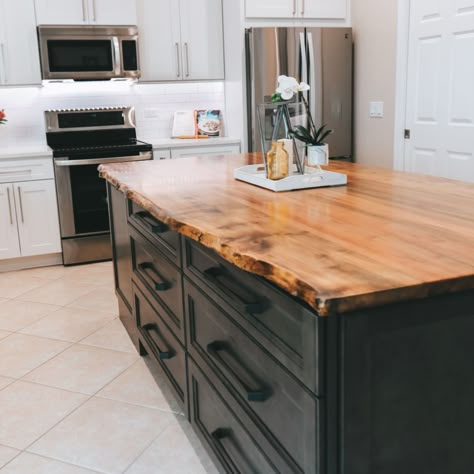 This natural wood live edge island counter top is the showcase of this beautiful kitchen. Wood Countertops Kitchen Island, Wood Island Countertop, Black Kitchen Countertops, Kitchen Island Tops, Wood Countertops Kitchen, Natural Wood Kitchen, Black Kitchen Island, Wood Countertop, Wood Kitchen Island