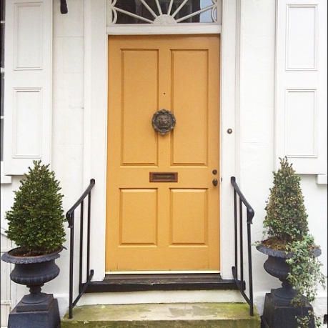 Mustard Yellow | One of our favorite aspects of the Holy City is the array of gorgeous street front doors—arguably the most charming of their kind in the South. Here, readers share Instagram snaps of beautiful Charleston doors. Share your photos with us by tagging @southernlivingmag or using #southernliving for a chance to be featured on SouthernLiving.com. Mustard Yellow Front Door, Orange Front Door, Yellow Front Door, Orange Front Doors, Exterior Door Colors, Yellow Front Doors, Greige Design, Sweden House, Front Door Paint Colors