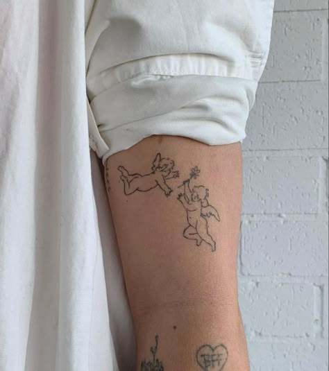 Small Cupid Tattoo, Small Cherub Tattoo Simple, Two Cherubs Tattoo Simple, Small Cherub Tattoos For Women, Cherub Tattoo Back Of Arm, Minimal Cherub Tattoo, Cupid Tattoo, Cherub Tattoo, Petite Tattoos