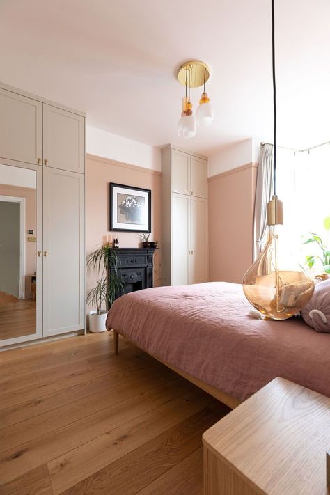 A stunning bedroom renovation in off peach walls, pink bedding and timber furniture, adding warmth to the main bedroom. The elegancy of the Tala pendants hanging either side of the bed for decorative + focal lighting adds to the character of the room. Read more about this project here! Do you need help with your London or Brighton renovation? Contact us now! Renovation by Absolute Project Management, photography by Moon Street Studio. #renovation #bedroom #interiordesign #aesthetic #art #pink Peach Bedroom Aesthetic, Aesthetic Art Pink, Complete House Renovation, Reclaimed Fireplace, Renovation Bedroom, Studio Renovation, Peach Bedroom, Bifold Patio Doors, Contemporary Design Style