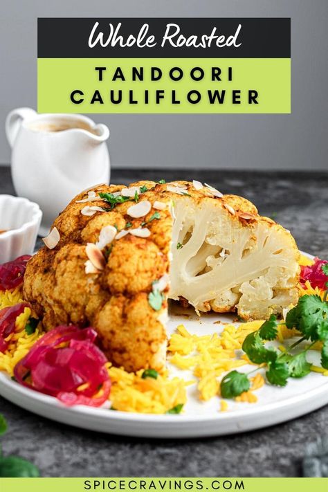 Whole roasted Tandoori Cauliflower is a 30-minute, impressive Indian vegetarian dish, in which a flavor-packed, roasted cauliflower head is served with homemade gravy and pickled onions! #roastedcauliflower #vegetablesidedishes #indianrecipes