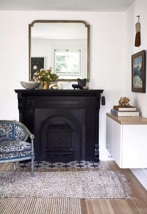 19 Painted Fireplace Ideas for a Cozy, Modern Update Black Fireplace Bedroom, Painted Wood Fireplace Surround, Blocked Fireplace Ideas, Stenciled Fireplace, Painted Fireplace Ideas, 1920s Fireplace, Painted Fireplace Mantels, Coal Fireplace, Retro Fireplace