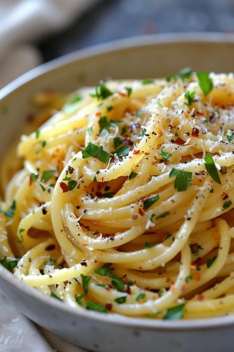 Indulge in the classic Italian flavors with our authentic spaghetti aglio e olio recipe. This simple yet flavorful dish features al dente pasta tossed in a garlic-infused olive oil sauce, finished with a sprinkle of red pepper flakes and parsley. Whether you're craving a quick weeknight meal or planning a special dinner, this recipe is sure to impress. Try making spaghetti aglio e olio at home and transport your taste buds to Italy! Pasta E Olio, Spaghetti Noodles With Olive Oil, Spaghetti Pasta Recipes Noodles, Pasta With Oil And Garlic Aglio Olio, Spaghetti Olive Oil Garlic, Authentic Aglio E Olio Recipes, Olive Oil Butter Sauce For Pasta, Pasta Garlic Olive Oil, Spaghetti With Olive Oil And Garlic