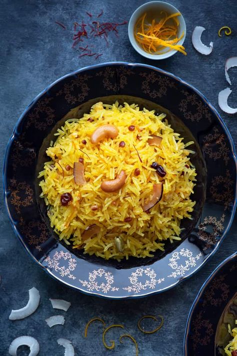 A close-up shot of Zarda pulao (sweet rice) served on a blue plate. Some orange zest, coconut slices spread around Zarda Rice, Zarda Recipe, Rice Pulao, Pulao Rice, Basmati Rice Recipes, Seasoning Blends, Healthy Rice, Sweet Rice, Pulao Recipe