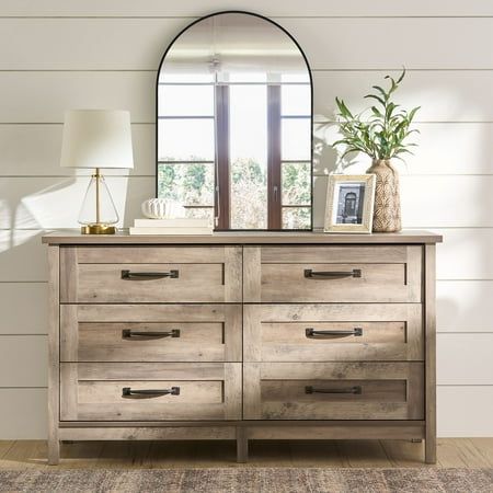 Create a rustic-inspired look while adding versatile storage options to your bedroom with this dresser from the Better Homes & Gardens Modern Farmhouse collection. This beautiful chest of drawers features six easy gliding drawers that open and close on smooth metal runners, making them ideal for convenient storage of an array of different items like stacks of button-up shirts and blue jeans to your collection of old t-shirts and sweat pants. It has room for all your stuff! Its spacious top surfa Rustic Dresser Decor, Dresser Top Ideas, Top Of Dresser Decor, Dresser Top Decor, Dresser Rustic, Dresser Styling, Modern Bedroom Wardrobe, Dresser Decor Bedroom, Rustic Dresser