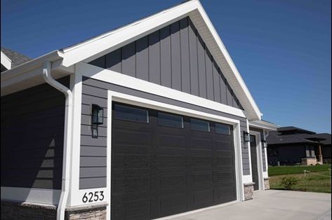 Garage Door Trim Ideas, Barn Shop Ideas, Door Trim Ideas, House Siding Options, Grey Garage Doors, Dark Grey Houses, Exterior Garage Door, Garage Door Trim, Wood Pillars