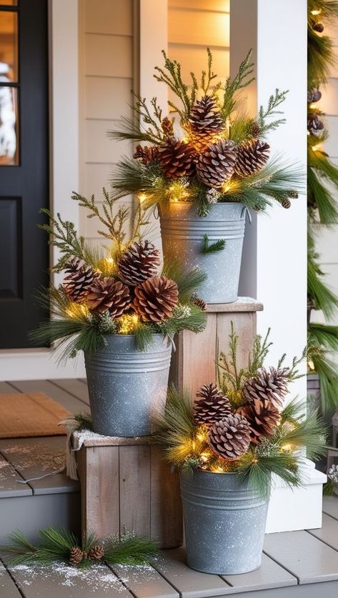 Holiday Porch Planter Ideas, Chair On Front Porch Decorating Ideas, Outdoor Christmas Decorations Flower Bed, Christmas Decor For Flower Pots, Outdoor Christmas Decor Theme, Large Christmas Lanterns Decorated, Farmhouse Christmas Outside Decor, Whiskey Barrel Planter Christmas Decor, Front Porch Decor Lanterns